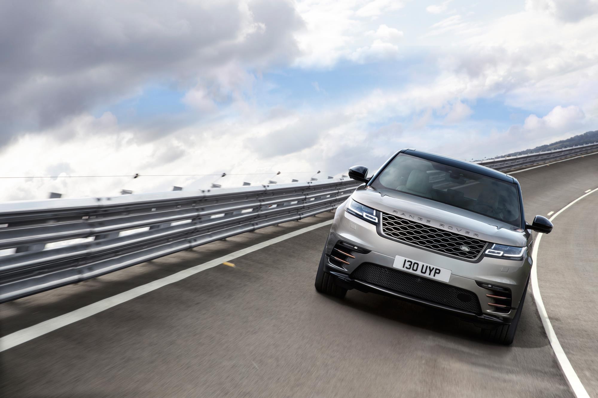 Pale gold metallic Range Rover Velar dring round a track towards you